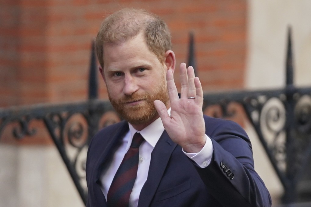 Prince Harry waves as he leaves the Royal Courts of Justice in London on Wednesday. Photo: AP