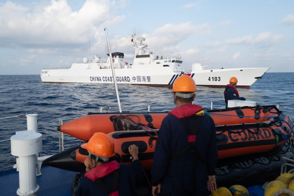Filipino coastguard crew look at a Chinese coastguard ship during a resupply run to the Second Thomas Shoal in March 2024. Photo: Jeoffrey Maitem