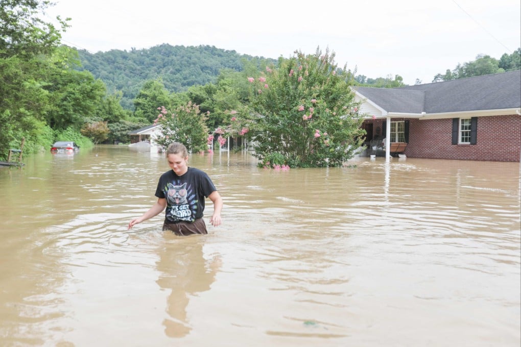 A woman in Kentucky in the US walks through waist-deep water after a flood in 2022. Scientists warn that global warming means once-rare events are increasingly likely. Photo: AFP