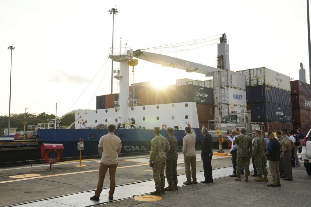 US and Panamanian officials wave to workers on a boat during a tour of the canal’s Miraflores Locks in Panama City on April 8. Photo: AFP