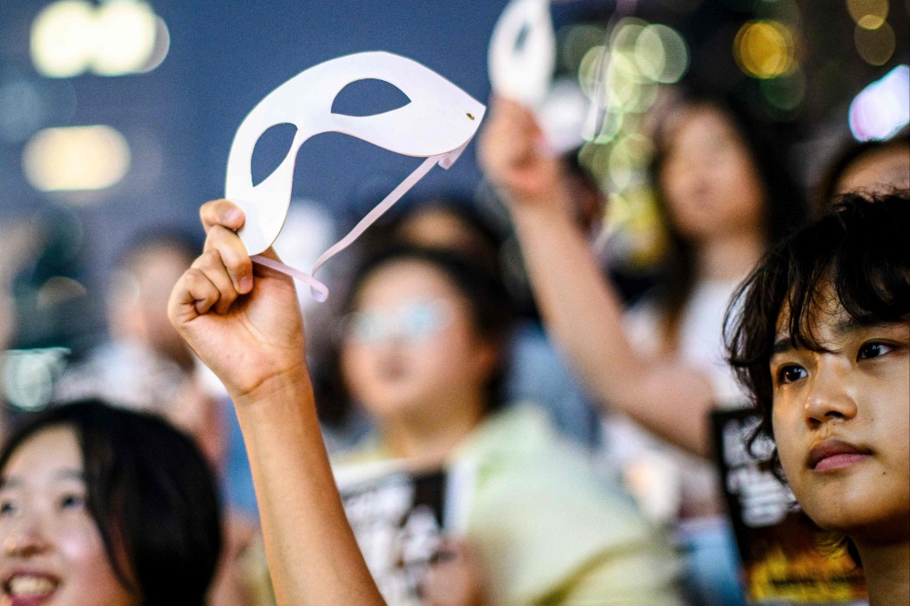 An activist holds an eye mask during a protest against deepfake porn in Seoul in August 2024. Photo: AFP