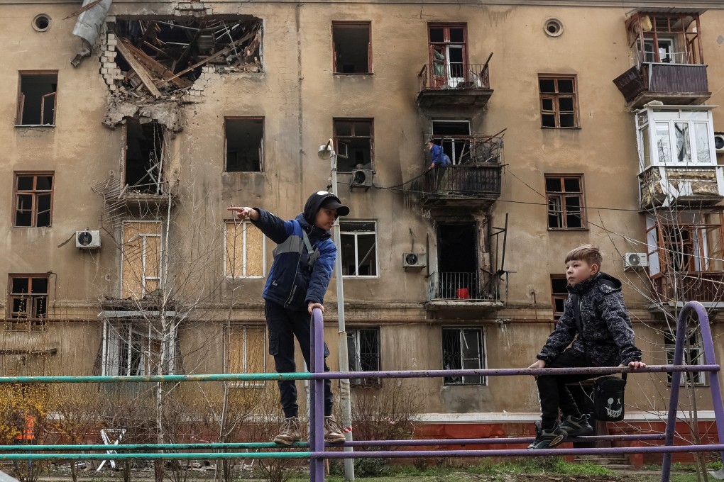 Children play near an apartment building hit by a Russian drone strike in Ukraine’s city of Kramatorsk on Wednesday. Photo: Reuters