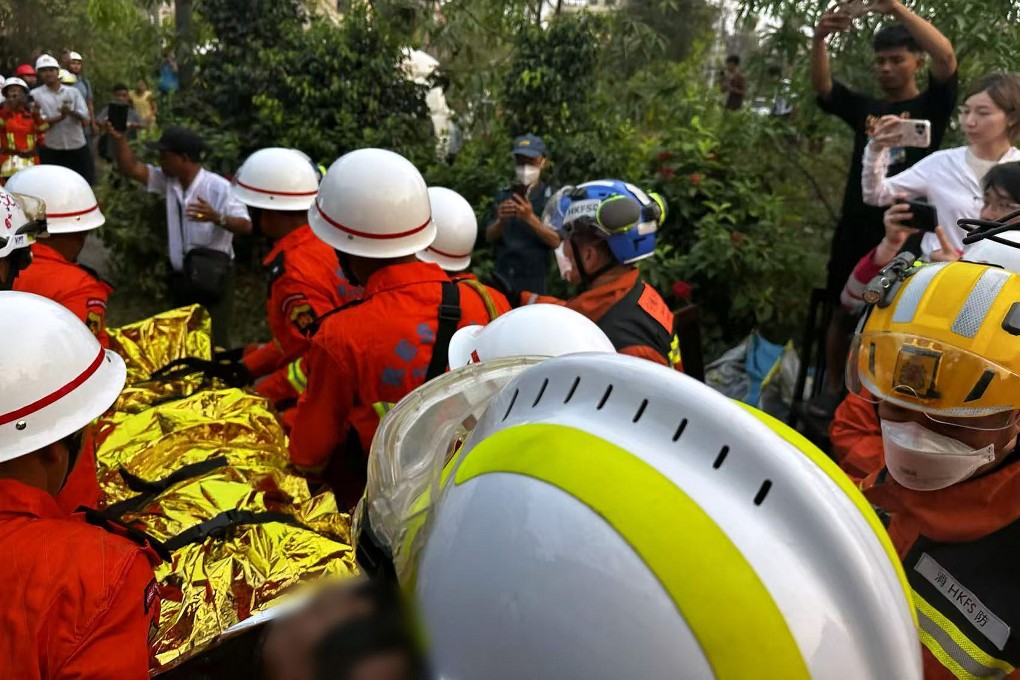 A Hong Kong rescue team carry a survivor away from the rubble of a Mandalay hotel in Myanmar. Photo: Handout