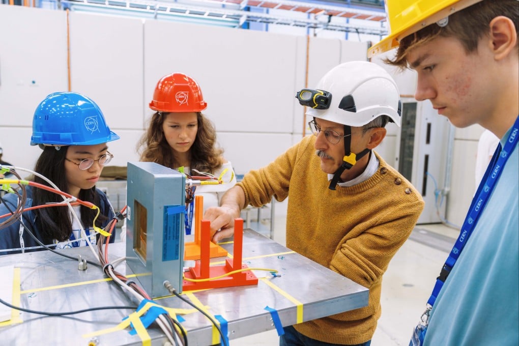 Students work on an experiment with Markus Joos (third left), technical director of the Beamline for Schools Competition, organised by CERN at its main research facility in Meyrin, Switzerland. Photo: Rolex/Nadir Mok