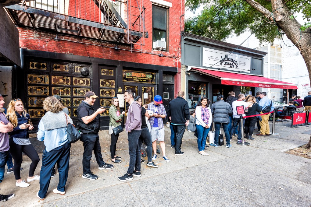 People waiting for a seat at Juliana’s Pizza, a neighbourhood pizzeria in New York. The city’s hottest tables may finally be free again with a law banning the reselling of restaurant reservations. Photo: Shutterstock