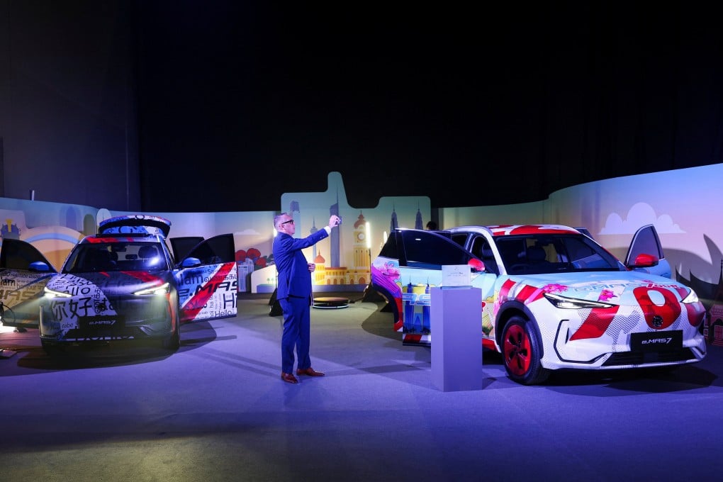 A man takes pictures of the e.MAS 7, the Malaysian auto firm Proton’s first electric vehicle. Photo: Reuters