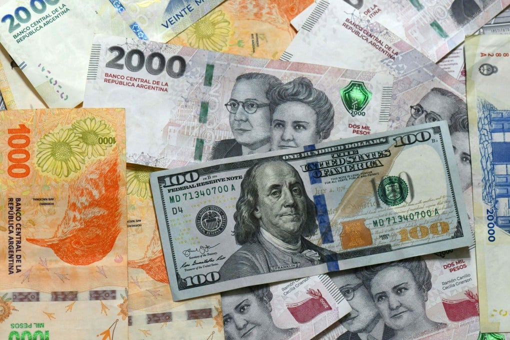 Argentinian pesos and US dollar banknotes in Buenos Aires. Argentina is dismantling key parts of its years-long currency controls and loosening its grip on the peso. Photo: AFP