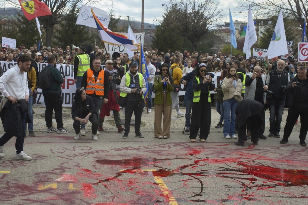 Protesters spill red paint in front of a local police station during an anti-corruption protest led by university students in the southwestern town of Novi Pazar, Serbia, on Saturday. Photo: AP