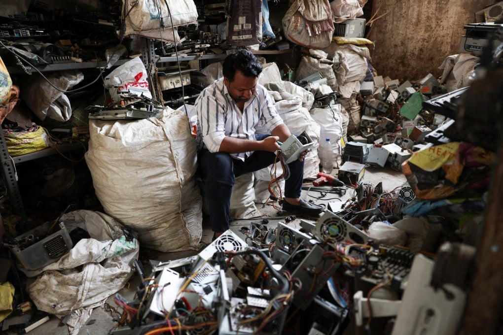 A man recycles electronic waste, or e-waste, from computer power supplies at a scrap yard in Ahmedabad, India, on Wednesday. Photo: Reuters