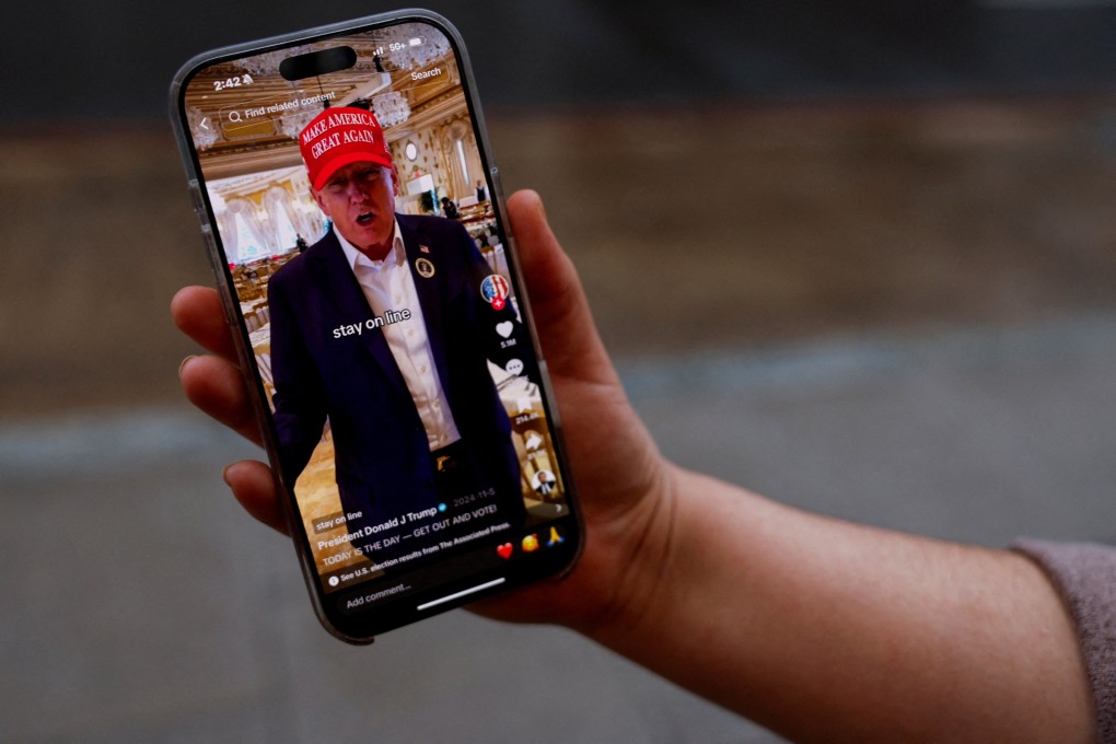 A woman poses with her smartphone displaying the @realdonaldtrump TikTok page, in Washington, US, on January 19. Photo: Reuters