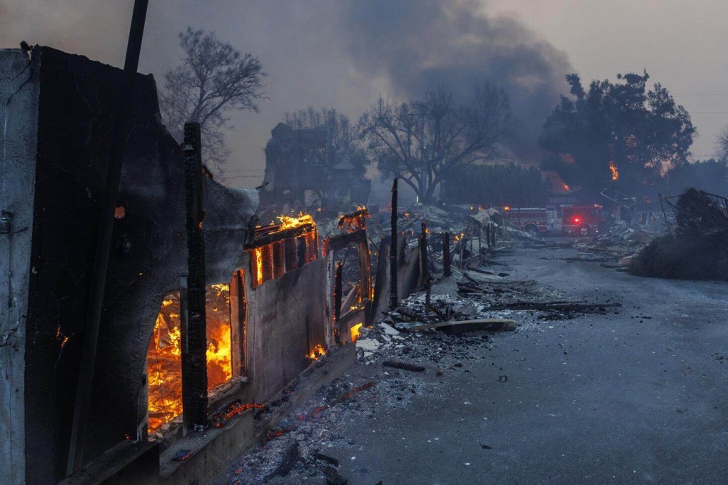 Homes smoulder during deadly wildfires in Los Angeles, California, in January. Photo: via TNS