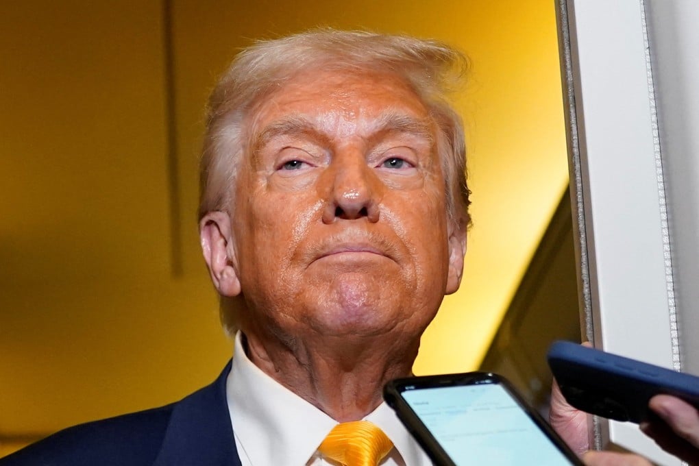 US President Donald Trump addresses the media on board Air Force One on his way to Florida on Sunday. Photo: Reuters