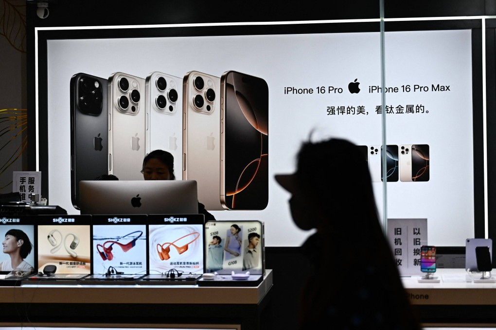 A woman walks past an electronics store at a shopping mall in Beijing on April 13, 2025. Photo: AFP