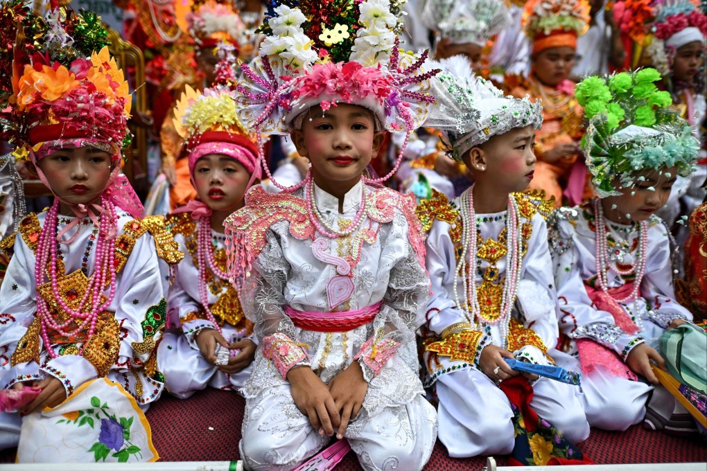 Ethnic Shan boys in shimmering clothes and colourful floral headpieces take part in a ceremony before they enter monastic life for between three days and one month – a rite of passage believed to bring merit and good fortune - at the Ku Tao temple in Chiang Mai, northern Thailand. Photo: AFP