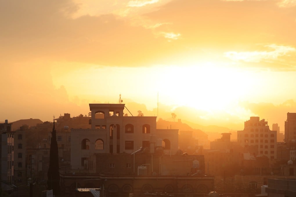 The sun sets through a blanket of clouds over Sanaa, Yemen, on Sunday. Photo: EPA-EFE