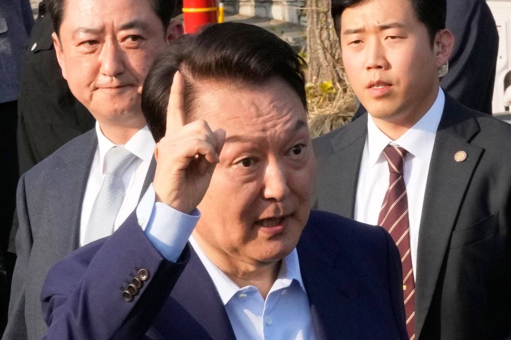 Yoon Suk-yeol gestures before leaving the presidential residence in Seoul on Friday. Photo: AFP