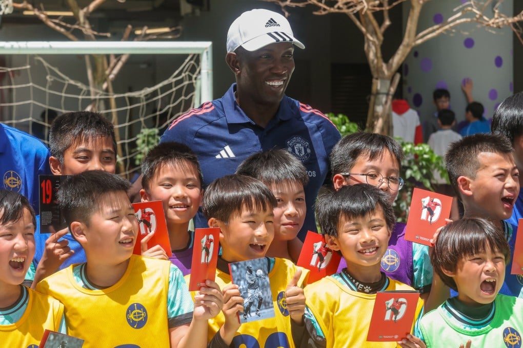 Former Manchester United footballer Dwight Yorke, visiting TWGHs Tsoi Wing Sing Primary School. Photo: Jonathan Wong