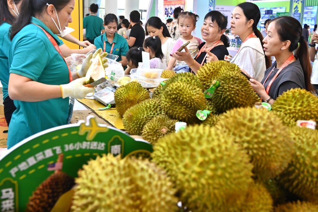 Visitors buy Malaysian durians in Nanning, south China. Photo: Xinhua