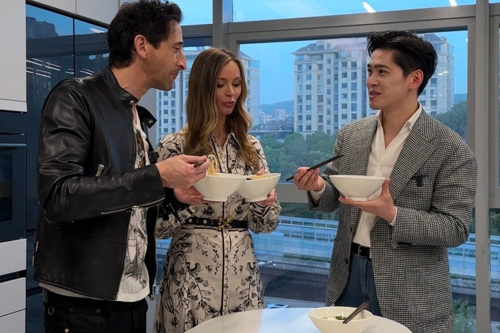 Adrien Brody (left) eats traditional Hangzhou-style noodles with his girlfriend Georgina Chapman and food blogger Vincent Xu. The Brutalist actor is set to appear at a fashion event in Quanzhou. Photo: Weibo