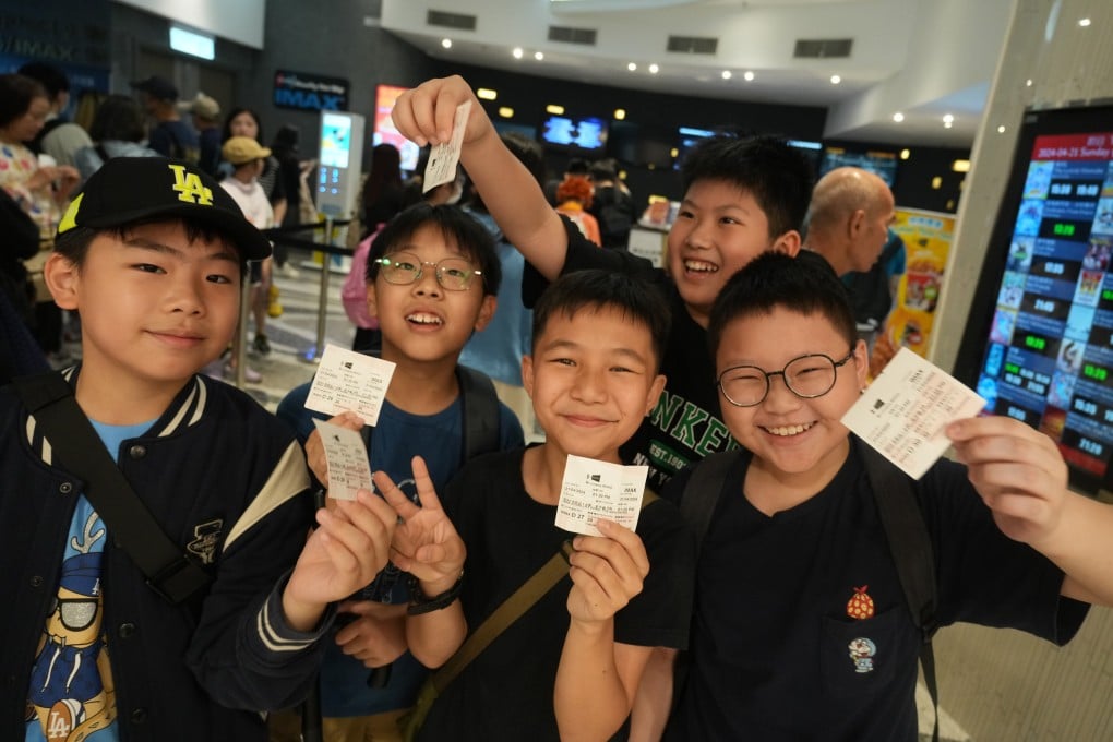 Happy film fans show off their tickets at a cinema in Mong Kok. Photo: Sam Tsang