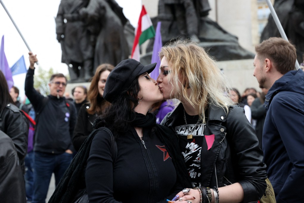 Protesters kiss during a demonstration outside the Hungarian parliament on Monday, the day it voted on constitutional amendments targeting the LGBTQ community. Photo: Reuters