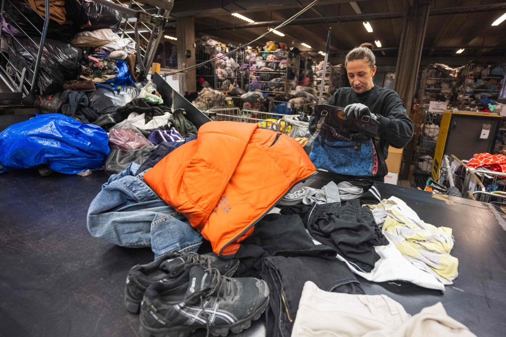 A worker sorts clothing at Artikel2’s sorting centre in Stockholm. Mountains of clothes piling up in Swedish recycling centres has sparked calls for firms to take responsibility for textile waste. Photo: AFP