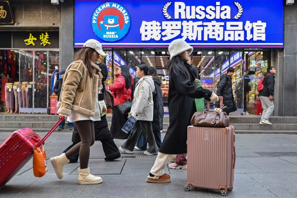 People walk past a store selling Russian goods in the neighbourhood of Qianmen in Beijing, on January 13. Photo: AFP