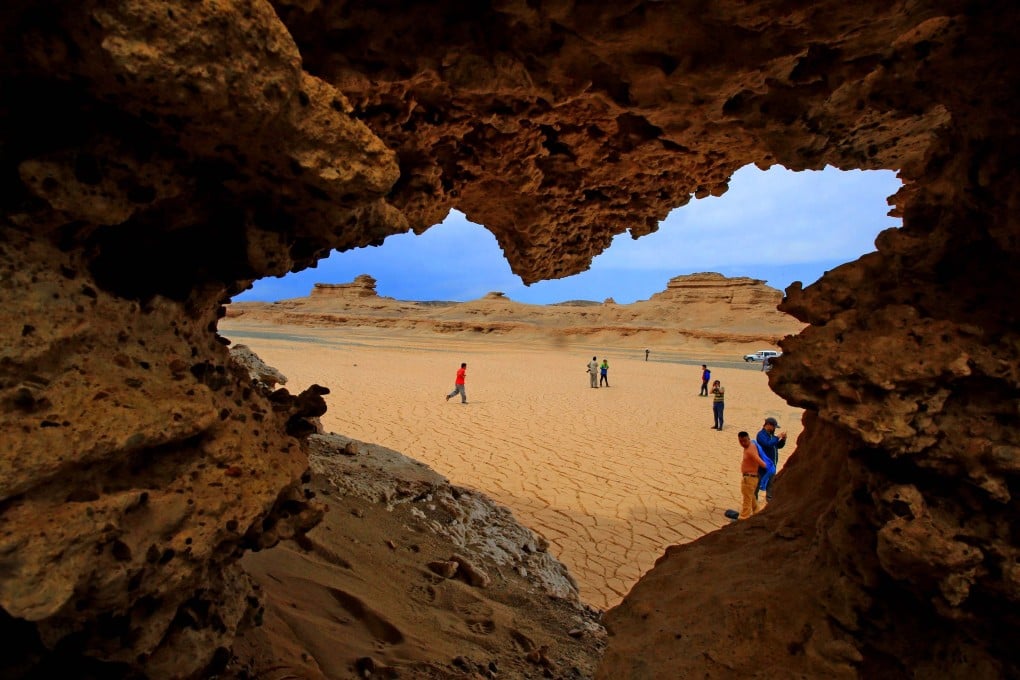 Tourists visit the Yadan landform, a landscape formed by wind erosion, in the Xinjiang region. Photo: Imaginechina