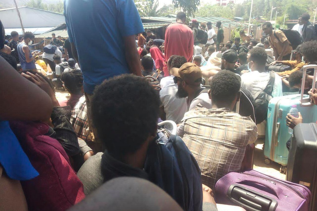 Men and women rescued from scam compounds in Myanmar sit inside a camp in Kyaukhat, Myanmar on Sunday, after their escape attempt to discuss their options for getting home. Photo: AP