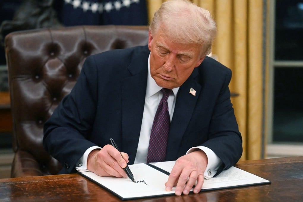 US President Donald Trump signs an executive order in the Oval Office of the White House in Washington. Photo: AFP