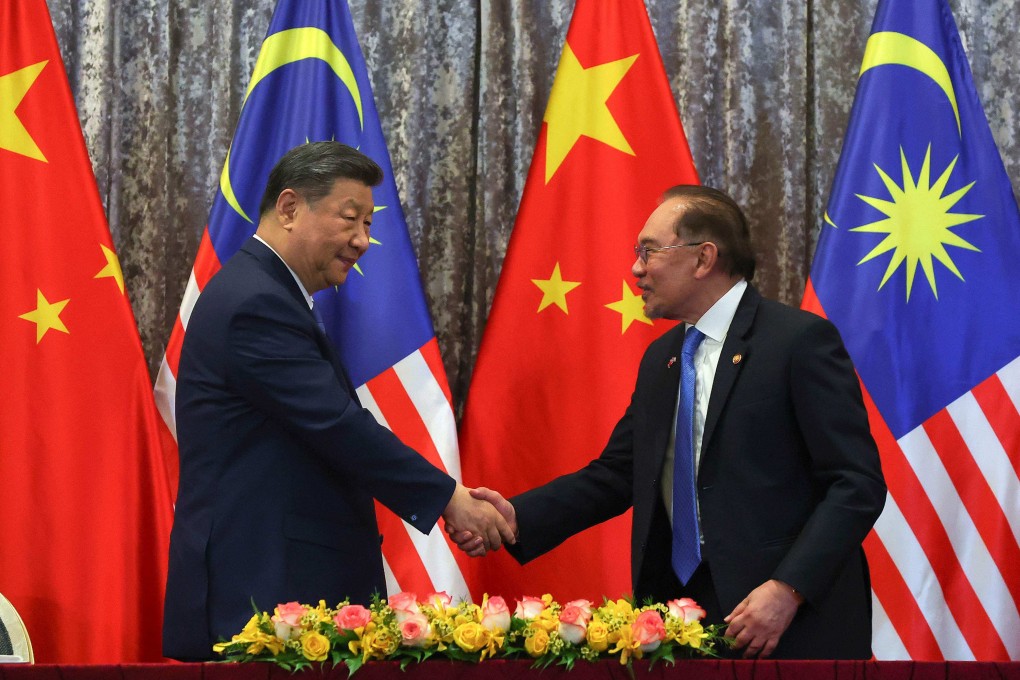 Xi Jinping and Anwar Ibrahim shake hands at the official residence of the prime minister outside Kuala Lumpur. Photo:  AFP