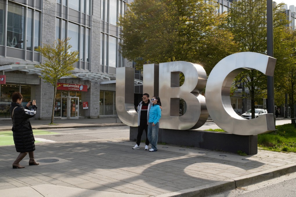 Family members take photographs at the entrance of the University of British Columbia (UBC) in Vancouver, Canada, on Monday. Photo: Reuters