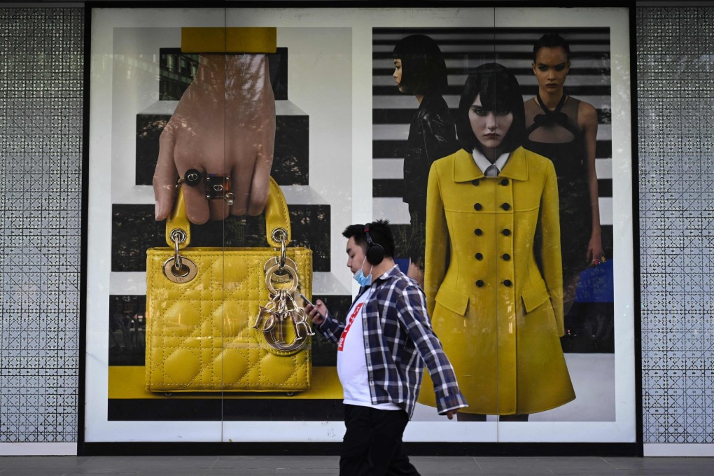 A man walks past a luxury store in Beijing’s financial district. Photo: AFP