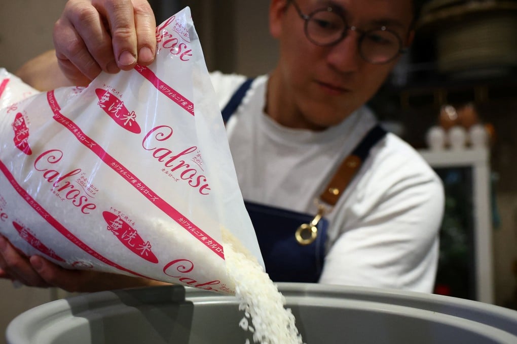 Arata Hirano, owner of the restaurant Shokudou Arata, pours California-grown Calrose rice into a rice cooker at his restaurant in Tokyo, Japan, on Sunday. Photo: Reuters