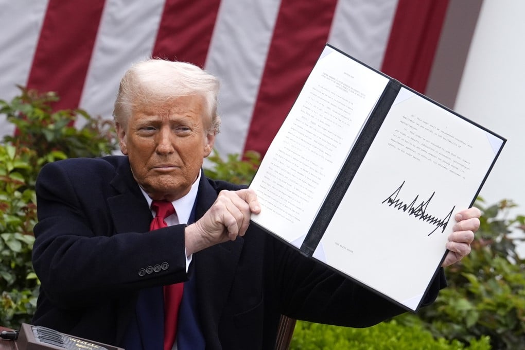 U.S. President Donald Trump signs an executive order on tariffs during the “Make America Wealthy Again” event in the Rose Garden at the White House on April 2. Photo: Abaca Press / TNS
