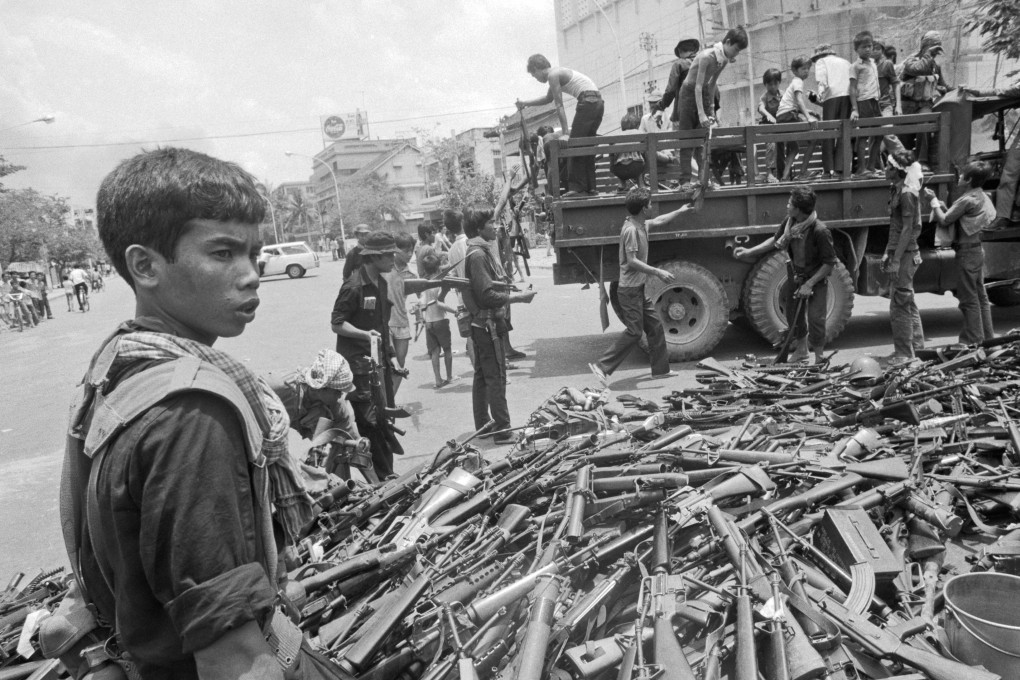 Khmer Rouge troops gather surrendered weapons at an intersection in Phnom Penh on April 17, 1975. Photo: Roland Neveu
