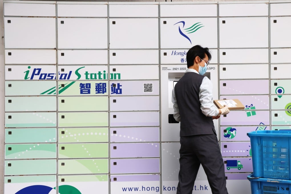 A Hongkong Post worker handles parcels in Central. Photo: Jelly Tse