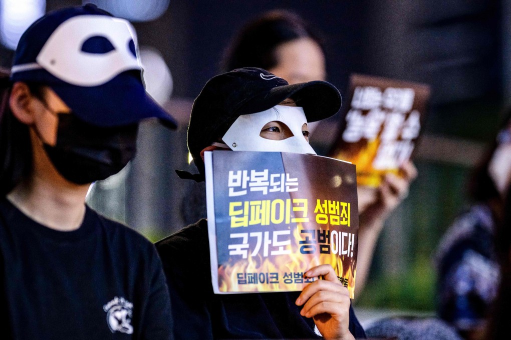 Activists wearing masks protest against deepfake porn in Seoul last year. The poster reads: “Repeated deepfake sex crimes, the state is an accomplice too”.  Photo: AFP