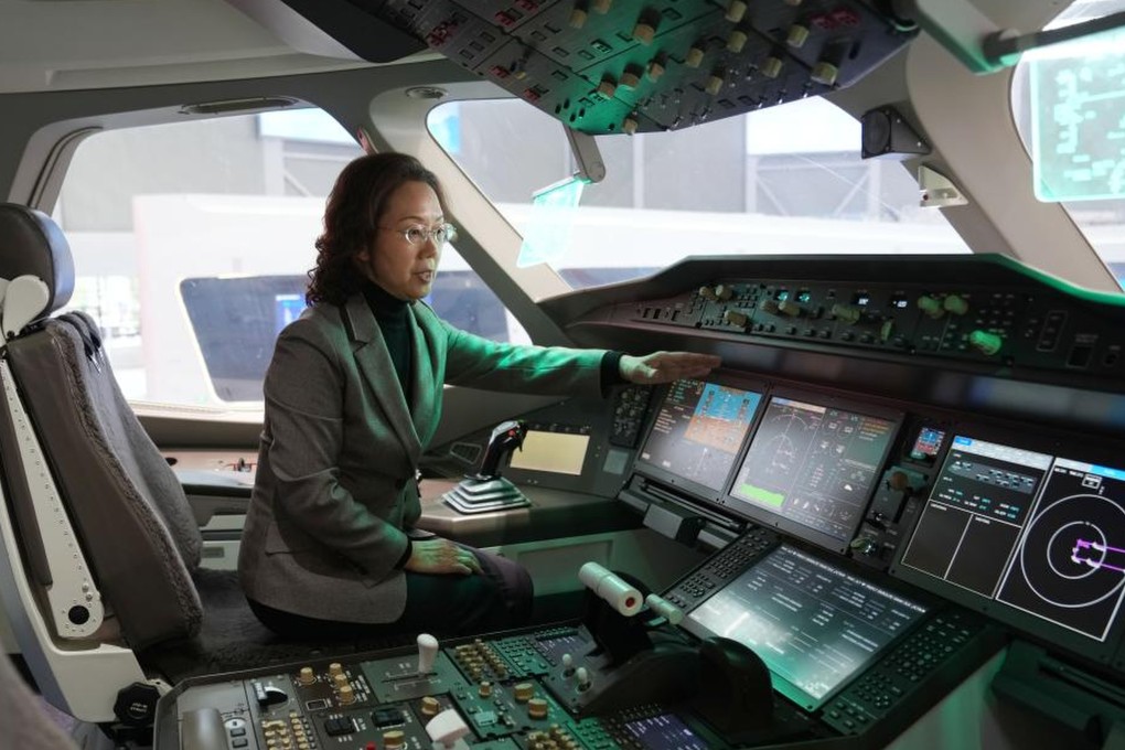 Zhao Chunling points out features of the C929’s cockpit inside a mock-up at a Comac research institute in Shanghai, on March 5. Photo: Xinhua