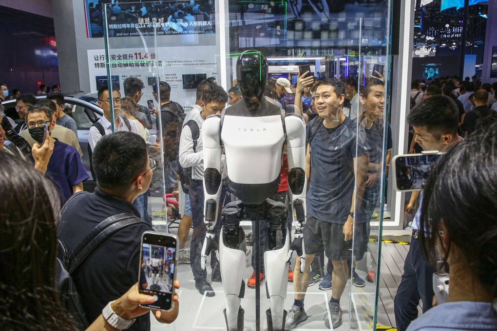 Visitors look at Tesla’s humanoid robot, Optimus, at its exhibition booth during the World Artificial Intelligence Conference in Shanghai last year. Many core components of humanoid robots developed by companies such as Tesla are sourced heavily from suppliers in China. Photo: AFP