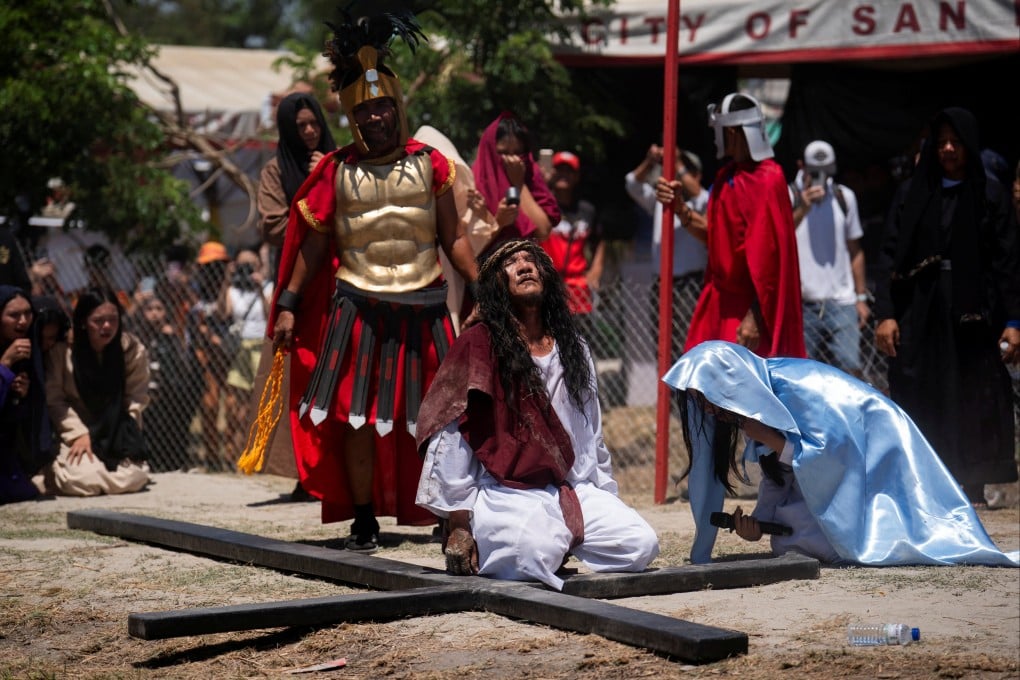 Ruben Enaje kneels on the ground during his reenactment of the crucifixion of Jesus Christ on Good Friday, in San Fernando, Philippines. Photo: Reuters