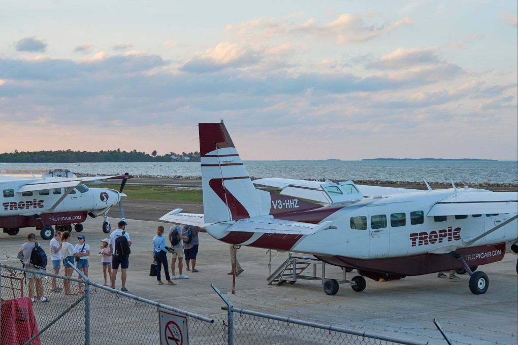 Tourists board a Tropic Air plane at the airport in Belize City on April 17. Photo: AFP