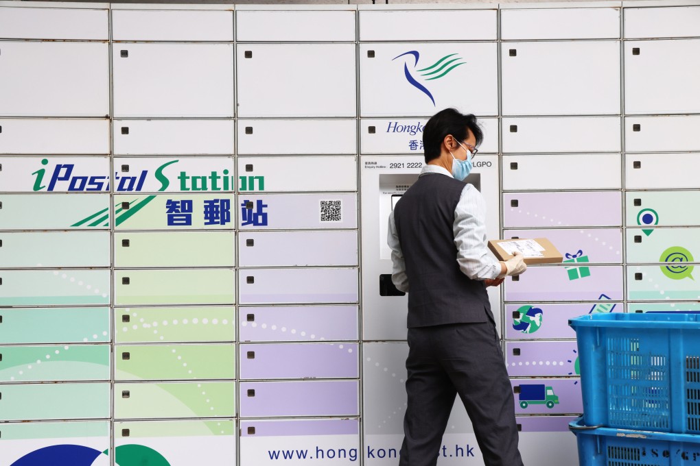 A Hongkong Post employee handles parcels outside the General Post Office in Central.  Hong Kong’s postal service said it will stop shipping goods bound for the US in response to “bullying” tariff hikes by US President Donald Trump. Photo: Jelly Tse