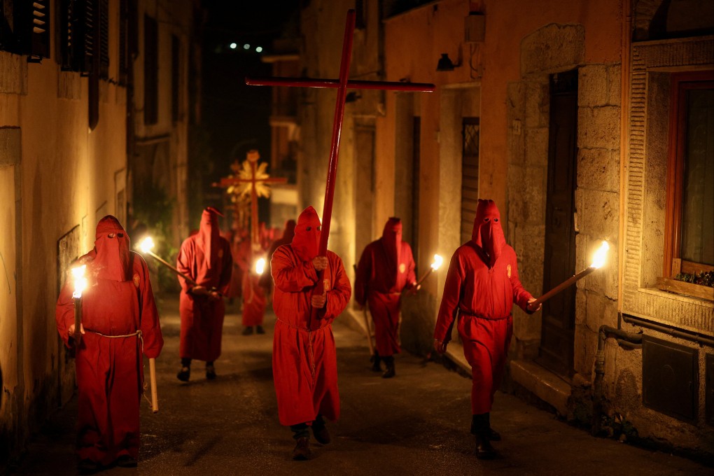 Penitents from a local religious confraternity known as “confratelli”, take part in the traditional Holy Week procession in Orte, central Italy, on Friday. Photo: Reuters