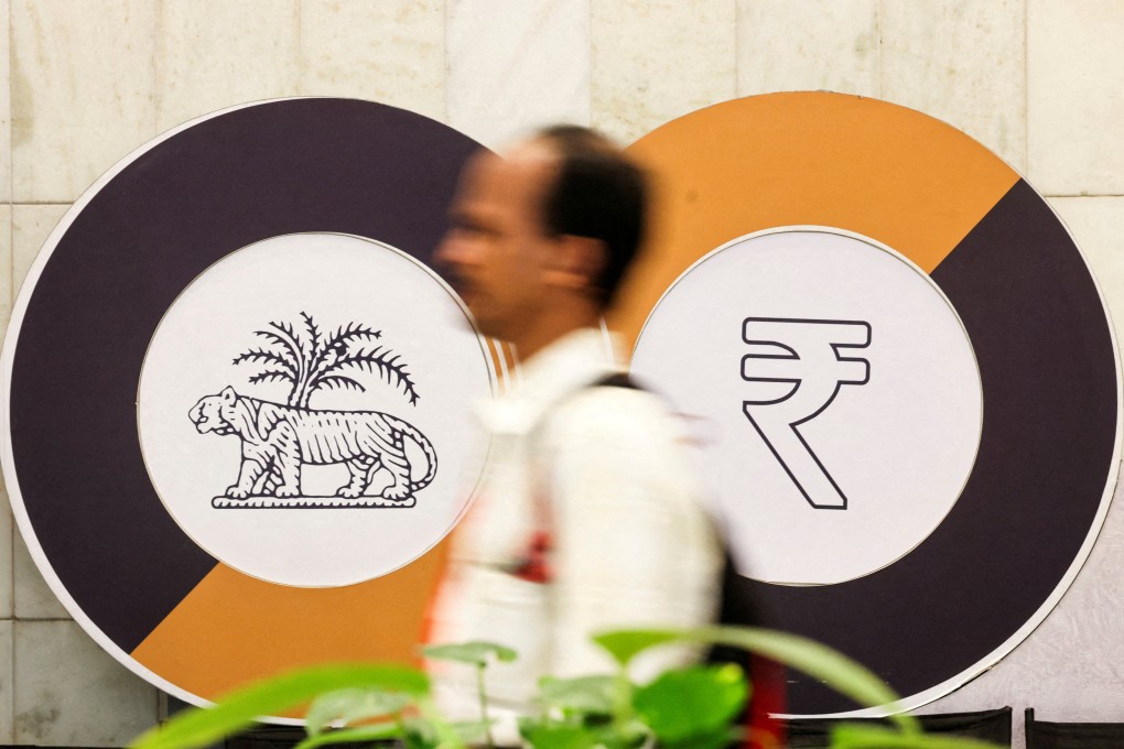 A man walks past a logo of the Reserve Bank of India (RBI) and the Indian Rupee inside the RBI headquarters in Mumbai on December 6. Photo: Reuters