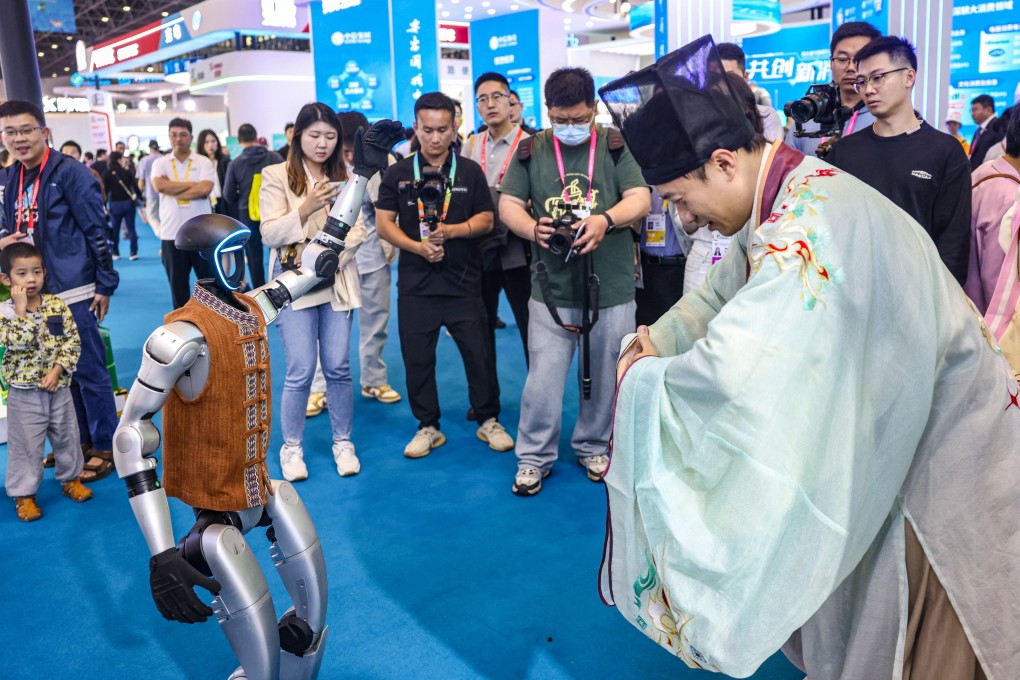 A visitor dressed in an ancient costume interacts with a Unitree humanoid robot at the 5th China International Consumer Products Expo in Hainan on April 13. Photo: Xinhua