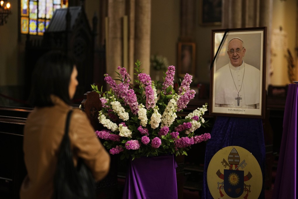 A person stands next to a photograph of Pope Francis inside Saint Anthony Catholic Church in Istanbul, Turkey on Monday. Photo: AP