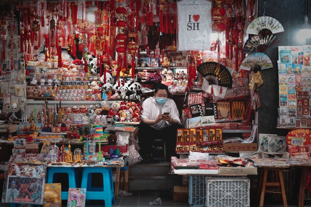 A woman sits at her booth at a market in Shanghai on April 16. Photo: EPA-EFE