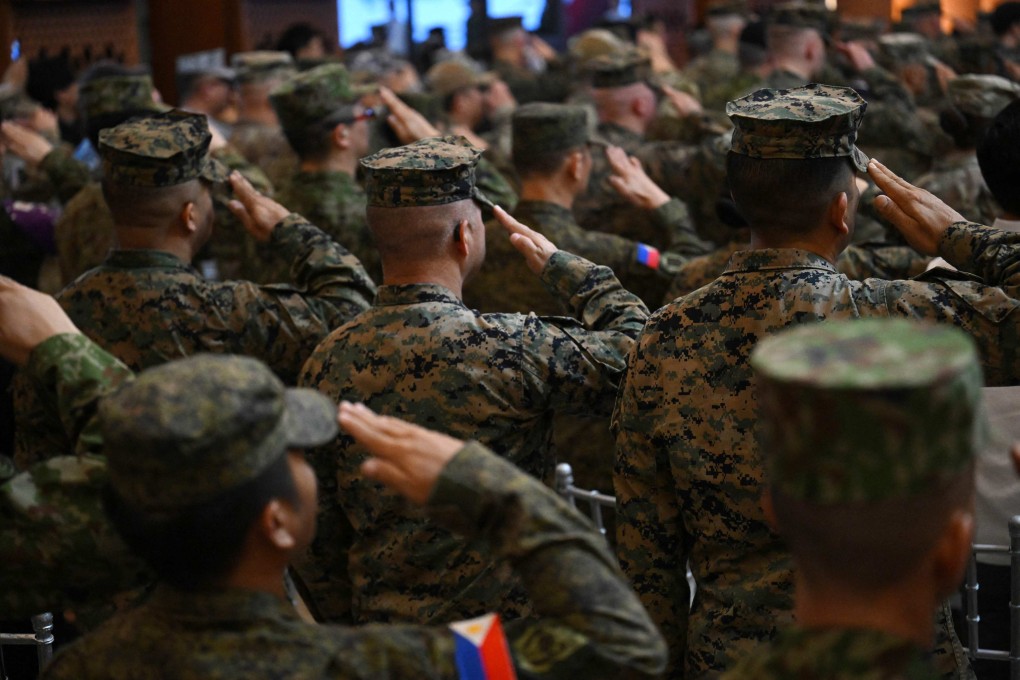 US and Philippine soldiers salute on Monday during the opening ceremony of the Balikatan joint military drills. Photo: AFP
