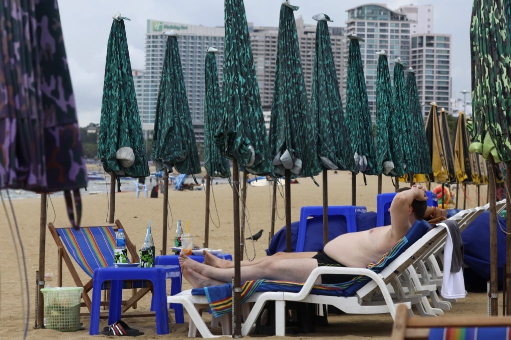 A foreign tourist sunbathes on a beach in Pattaya, Thailand. Photo: EPA-EFE